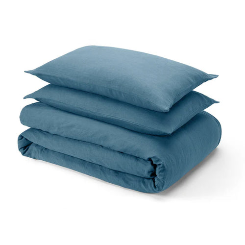 Aruba blue linen sheet set folded with pillowcase stacked on white background