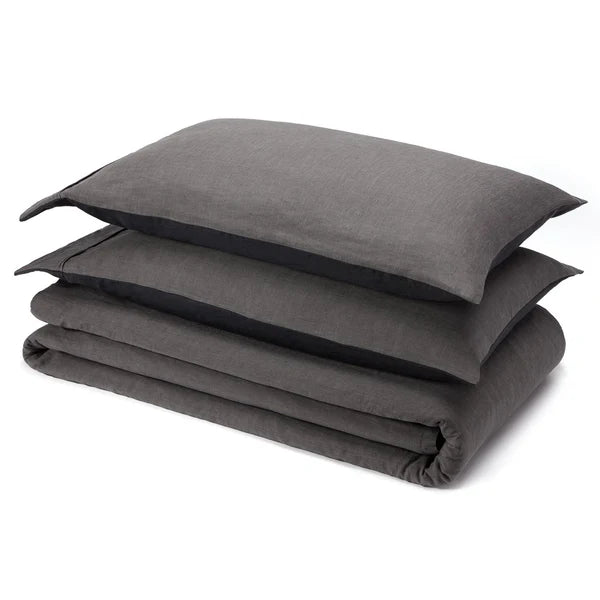 Charcoal linen sheet set folded with pillowcase on white background
