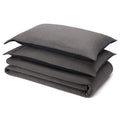 Charcoal linen sheet set folded with pillowcase on white background